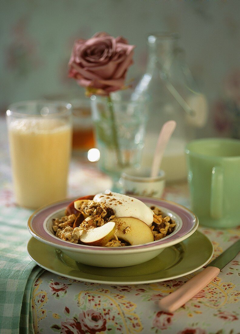 Muesli with apple and a glass of orange buttermilk