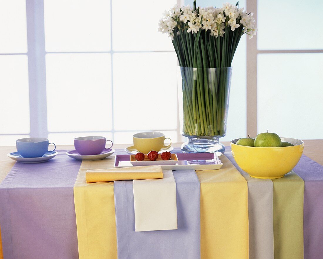 Table with pastel-coloured crockery and table linen