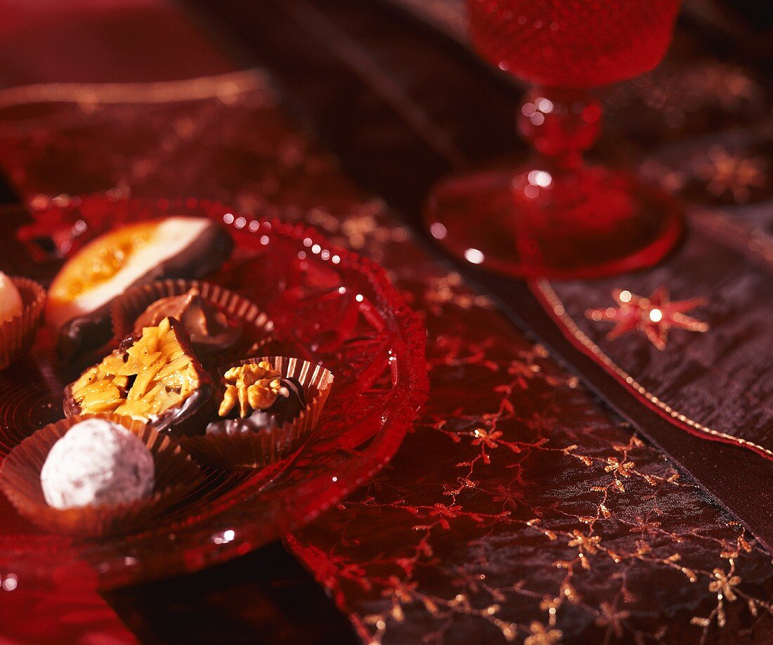 Assorted chocolates and sweets on glass plate (Christmas)