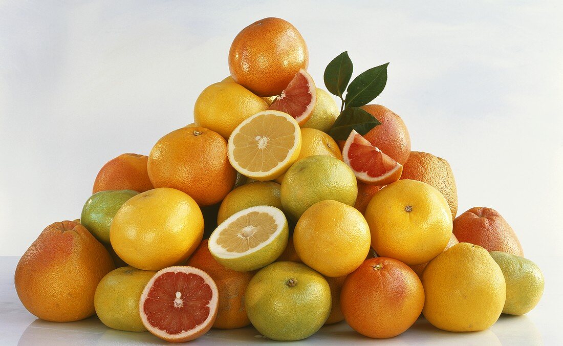 A heap of citrus fruit, whole and pieces