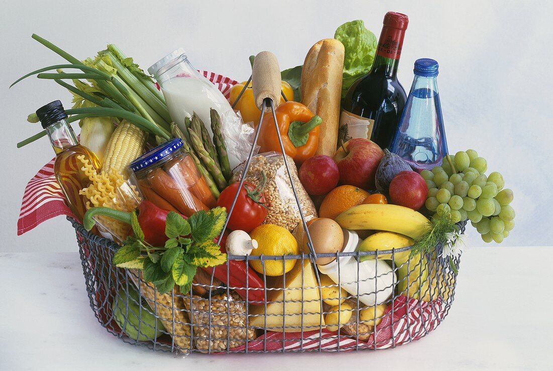 Shopping basket full of different foodstuffs