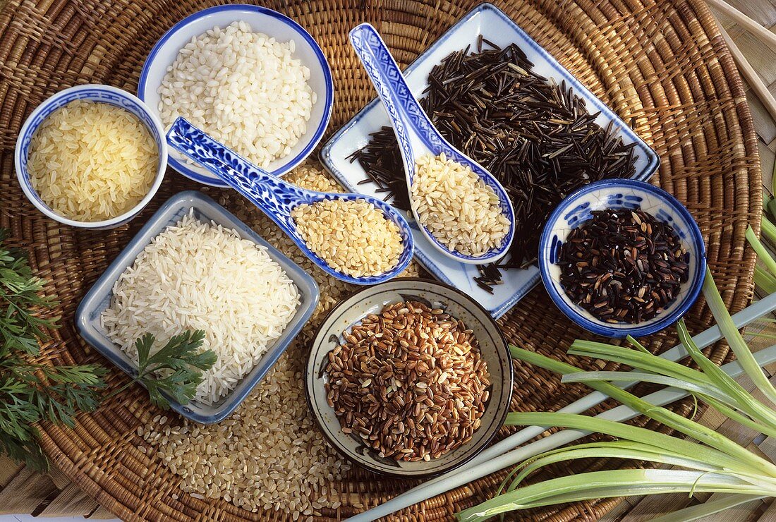 Various sorts of rice in dishes and on spoons