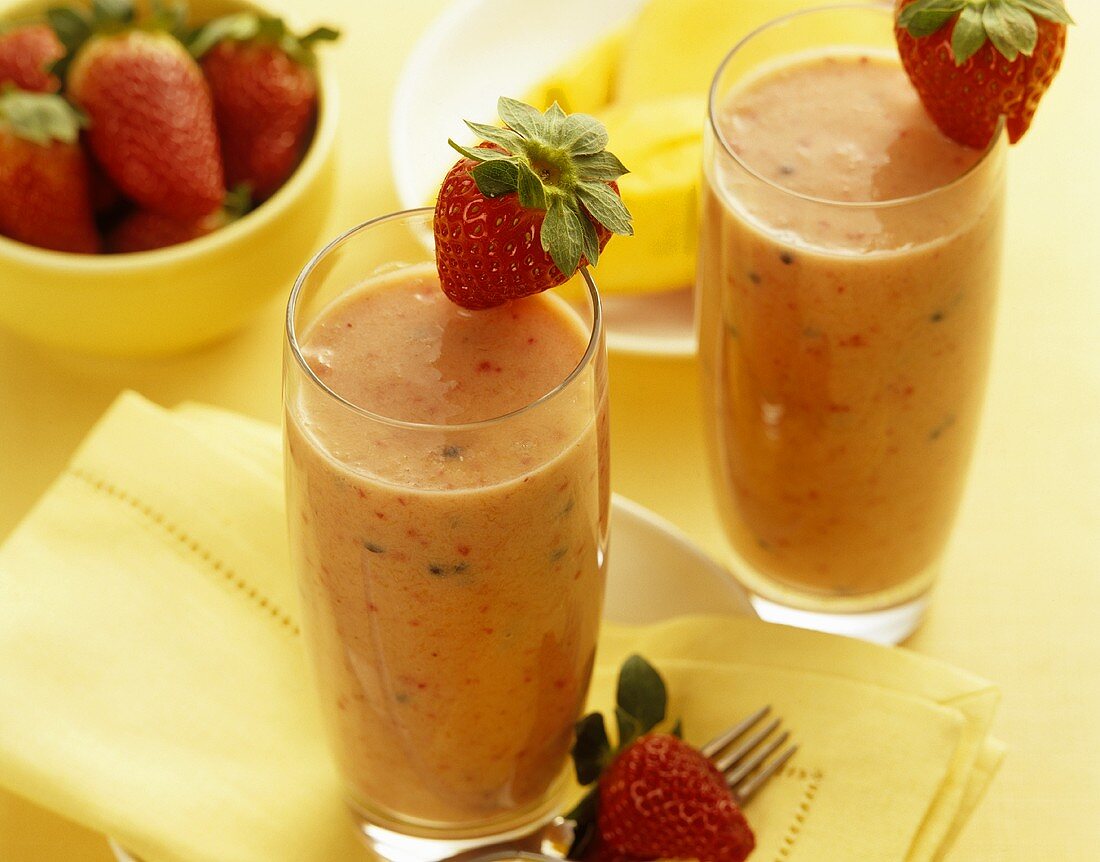 Two mango and strawberry smoothies