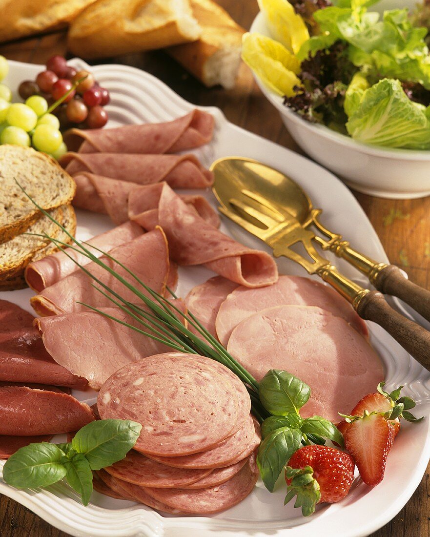 Cold cuts platter with lettuce and baguette