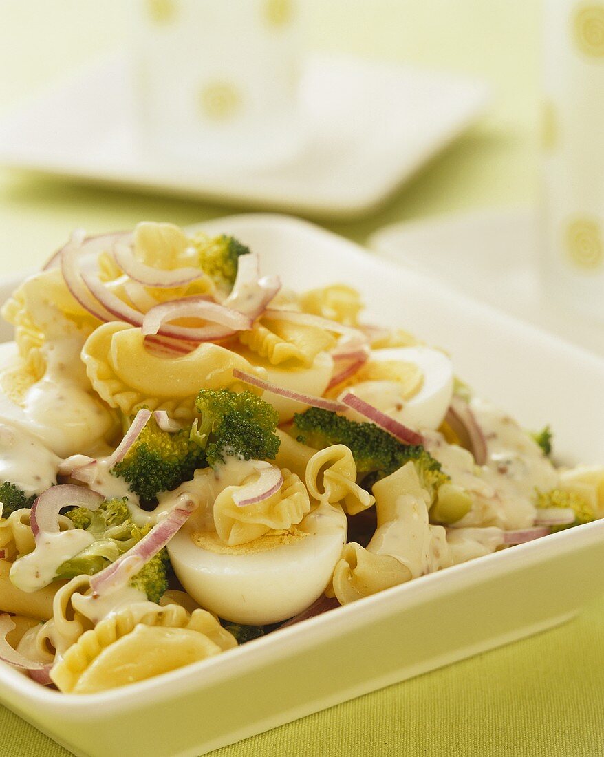 Pasta salad with broccoli, onion, egg and mustard mayonnaise dressing