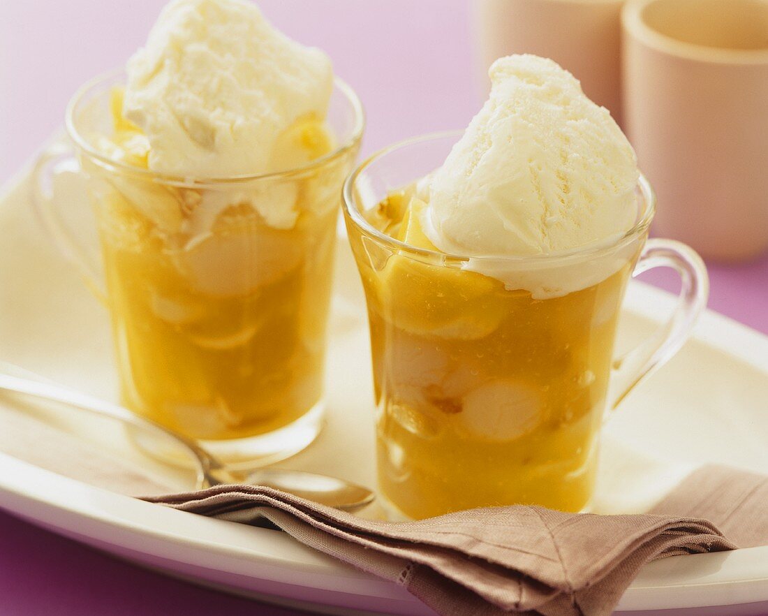 Exotic fruit compote with vanilla ice cream in two cups