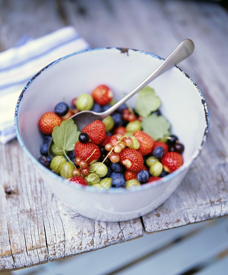 Bowl of fresh berries on a wooden table