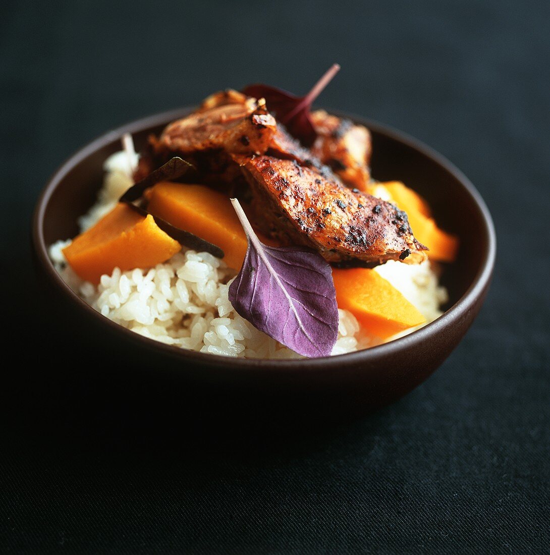 Duck with pumpkin on rice with red basil