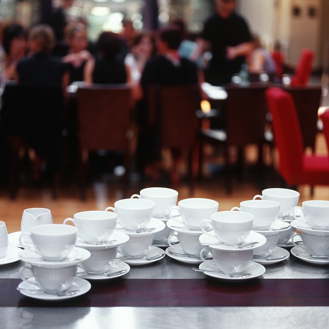 Many coffee cups on a table at a party