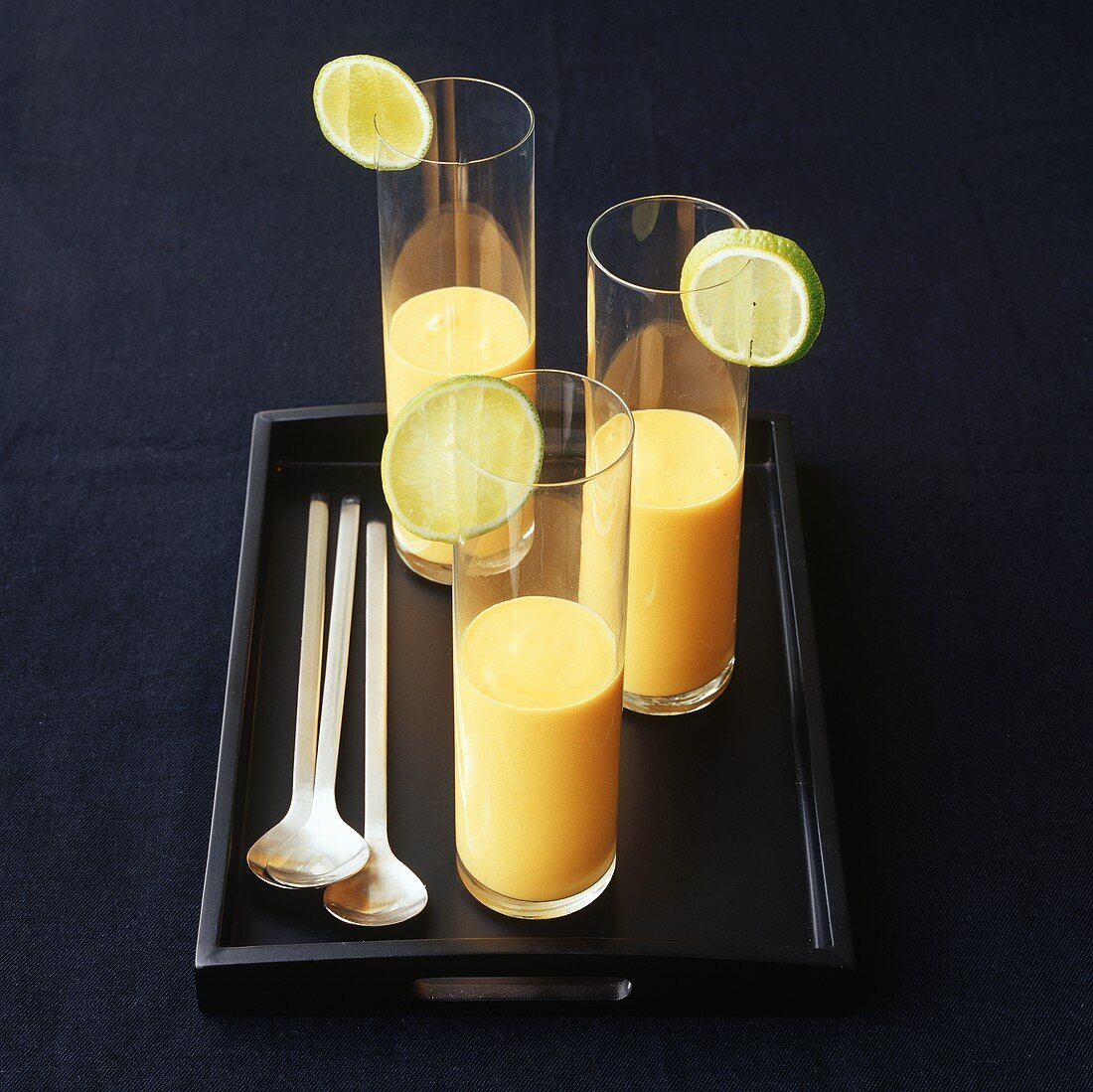 Mango laksa with lime in three glasses