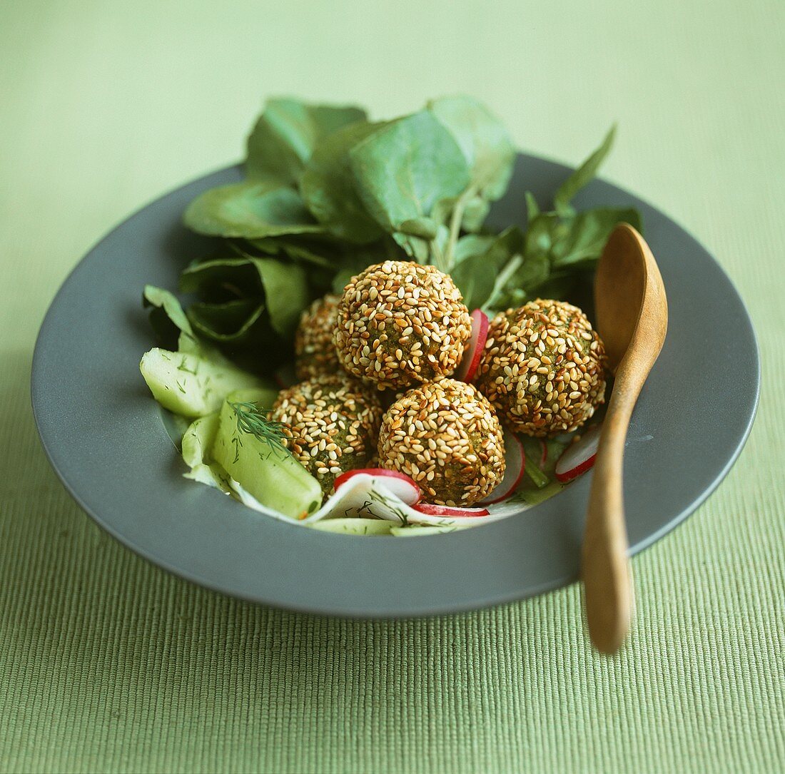 Sesame falafel with a water cress and cucumber salad