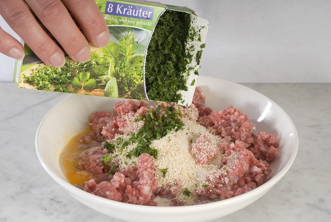 Adding herbs to meatball mixture