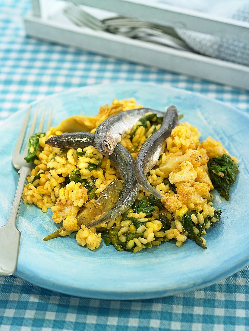 Rice with marinated sardines, spinach and artichokes (Spain)
