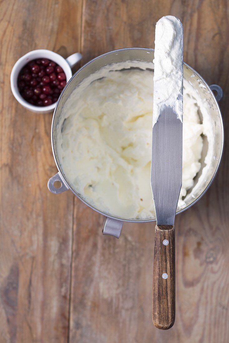 Whipped cream and redcurrants, seen from above