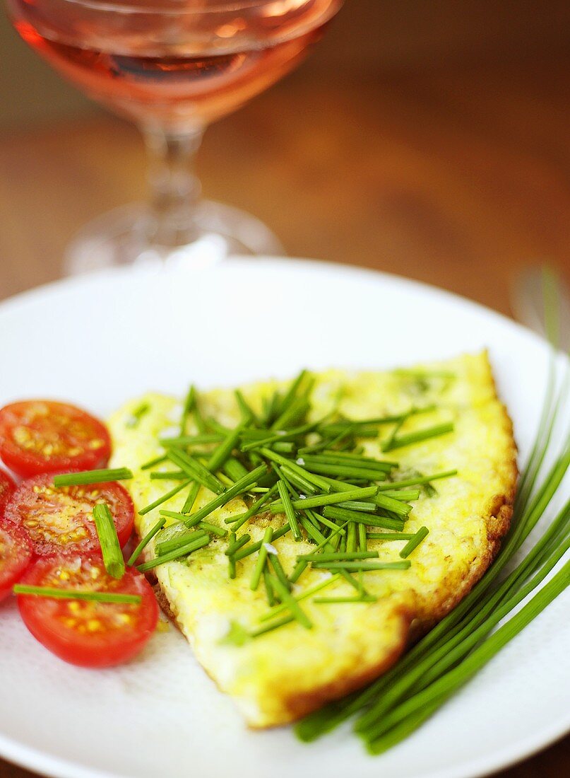 An omelette with tomatoes and chives