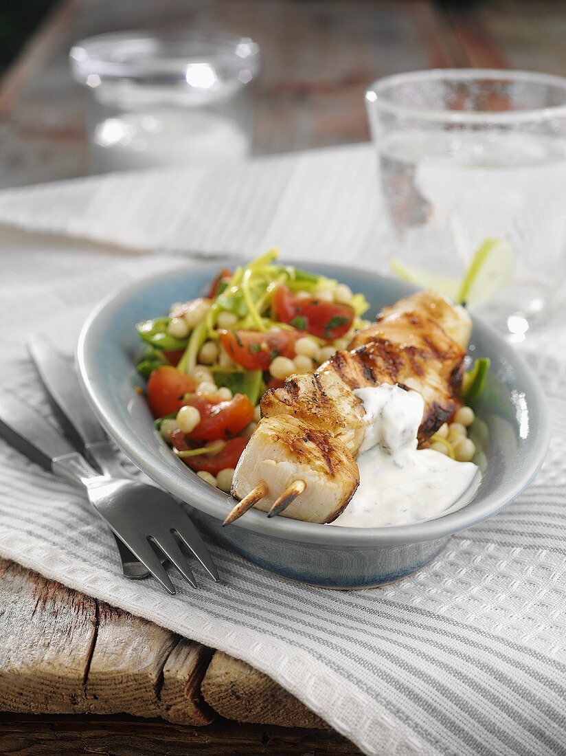 Scallop kebabs with tzatziki and vegetable salad