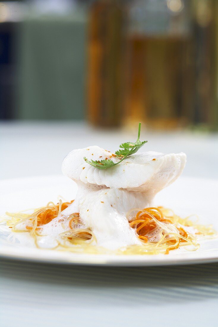 Poached John Dory in coconut milk on a bed of oriental noodles
