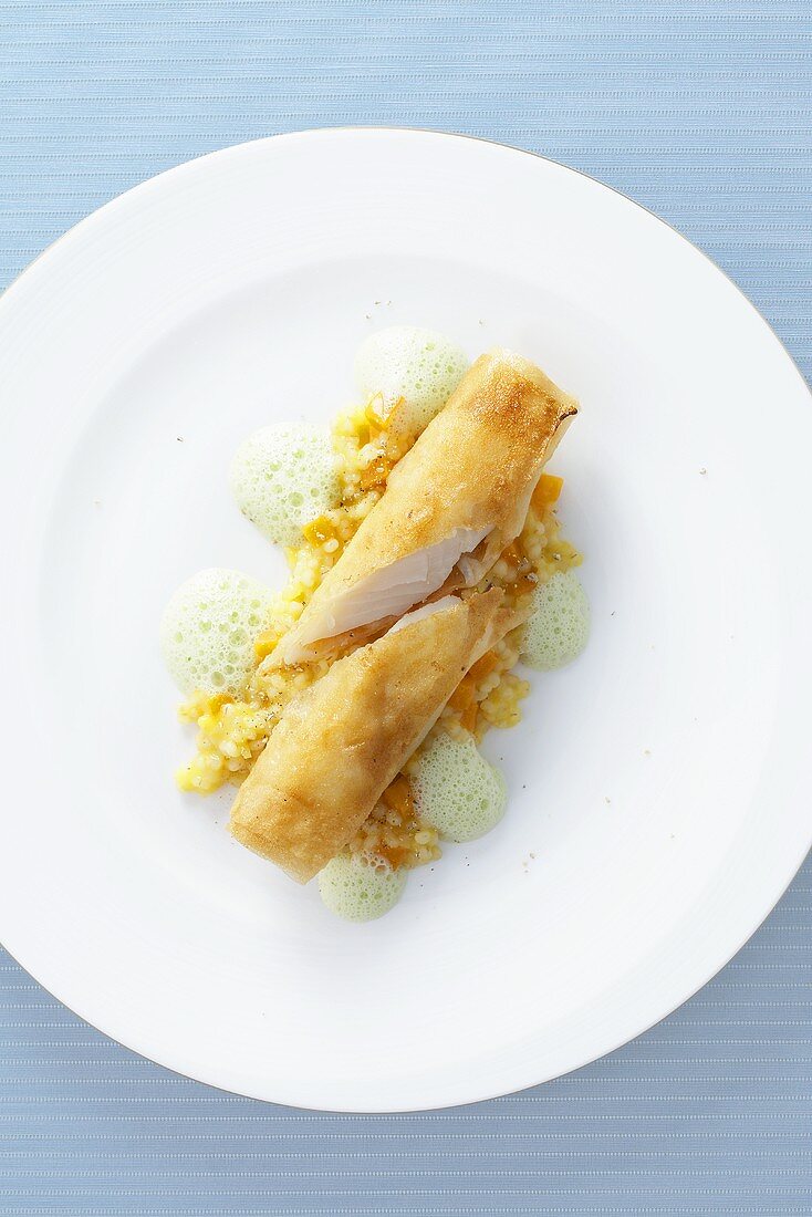 Halibut in puff pastry with pumpkin pearl barley and green curry foam