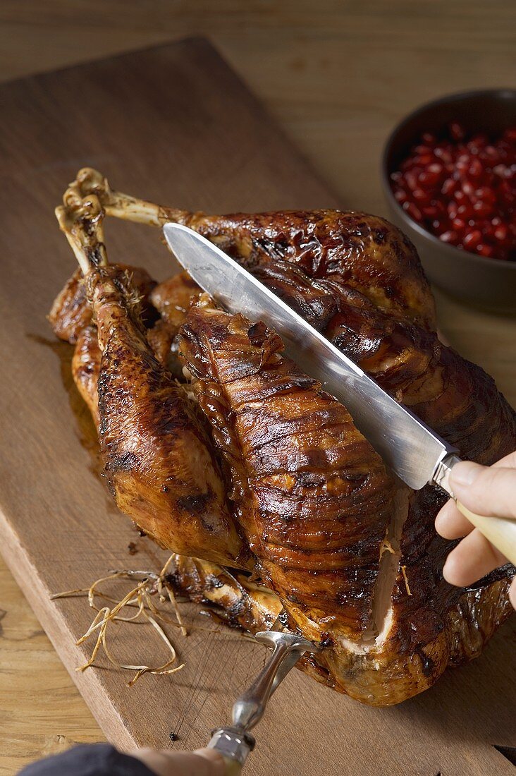 Roast turkey with pomegranate being carved