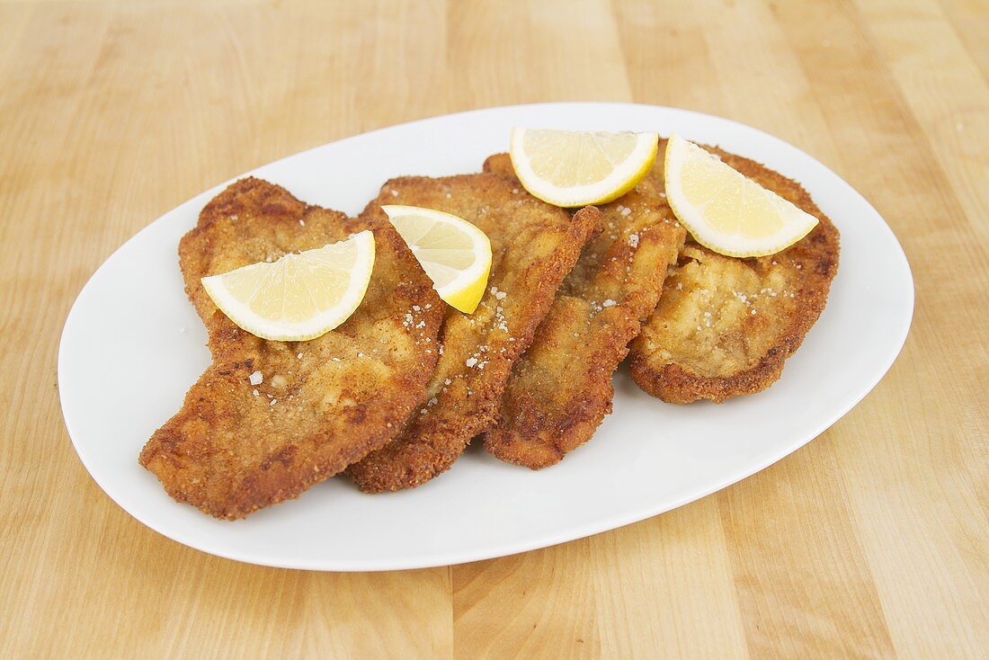 Veal escalope with lemon wedges