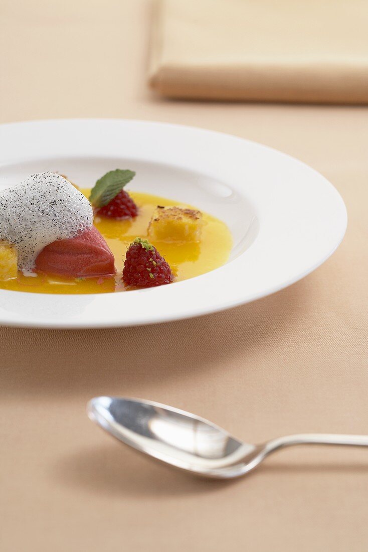 Iced mango soup with raspberry sorbet and candied ginger