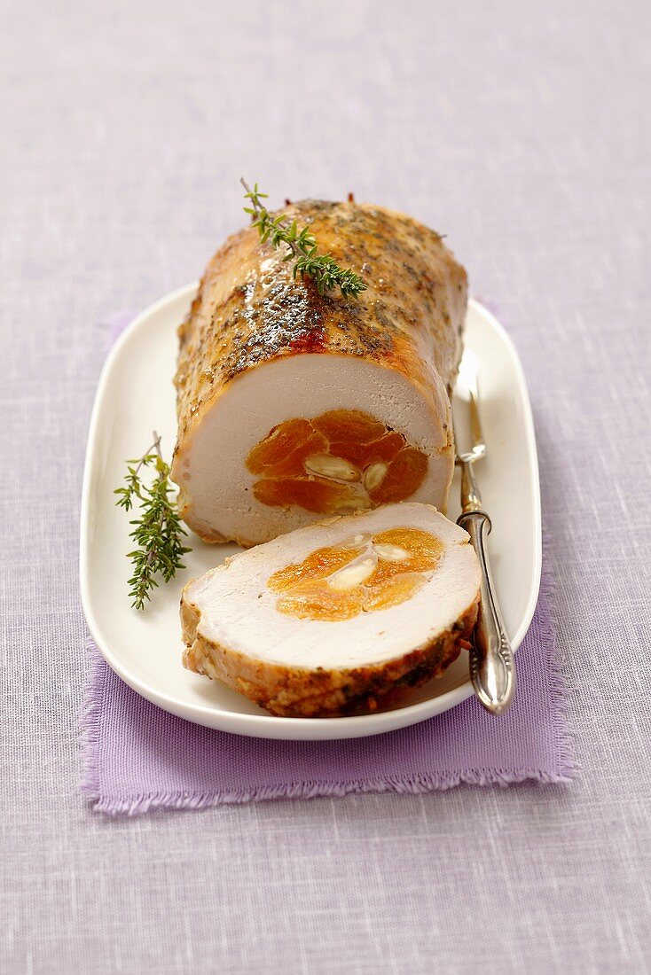 Stuffed roast pork with dried apricots and slivered almonds