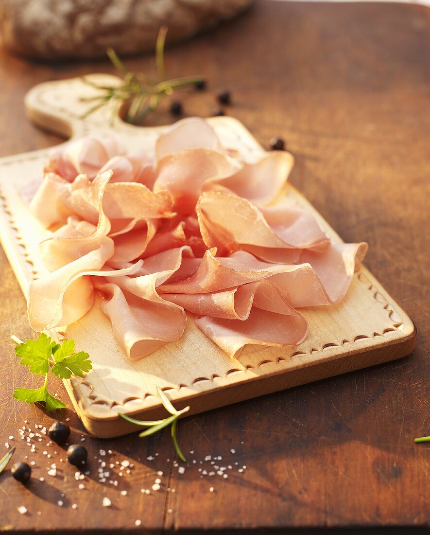 Sliced raw ham on a chopping board
