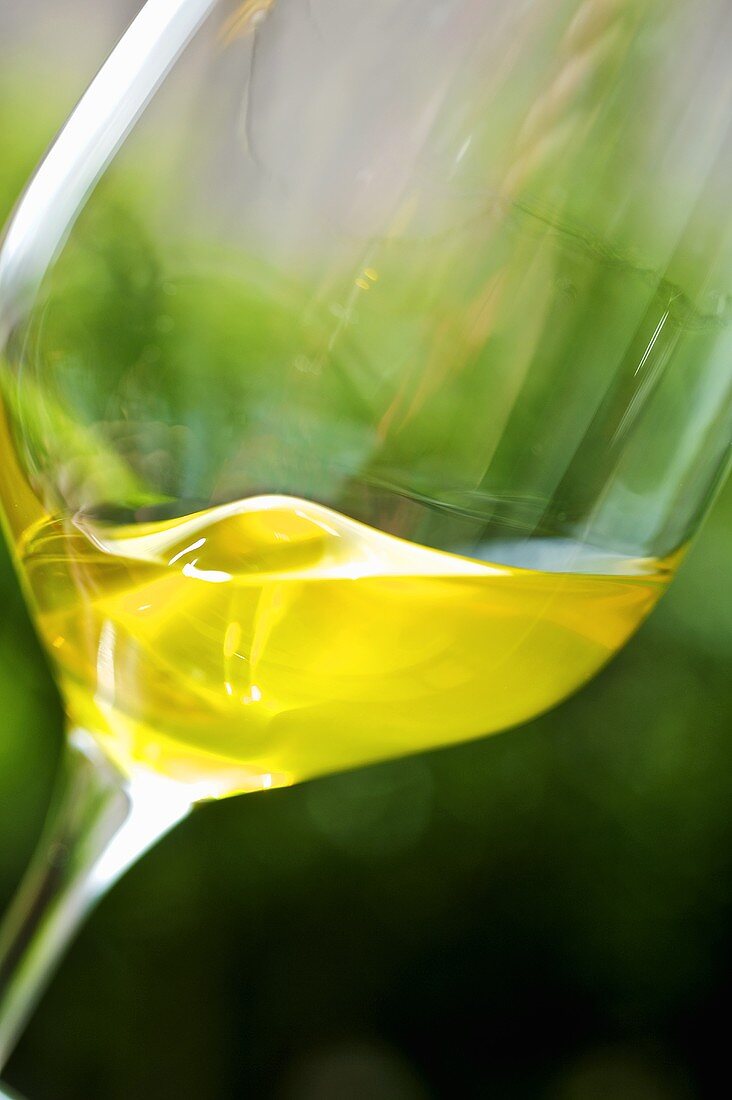 Olive oil being swirled in a glass