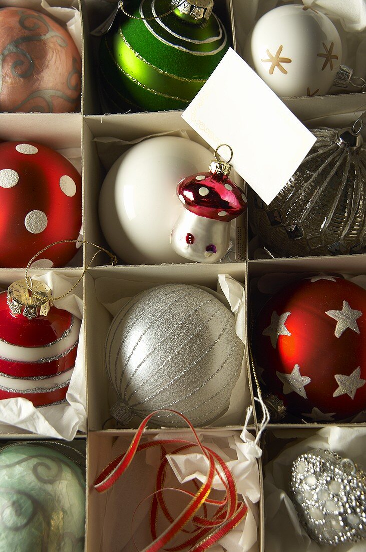 Various Christmas tree baubles in a box