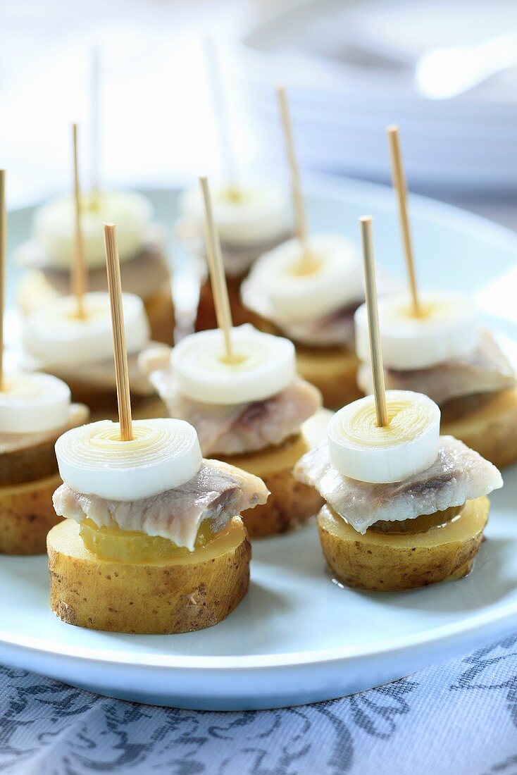 Potato canapes with herring and leek