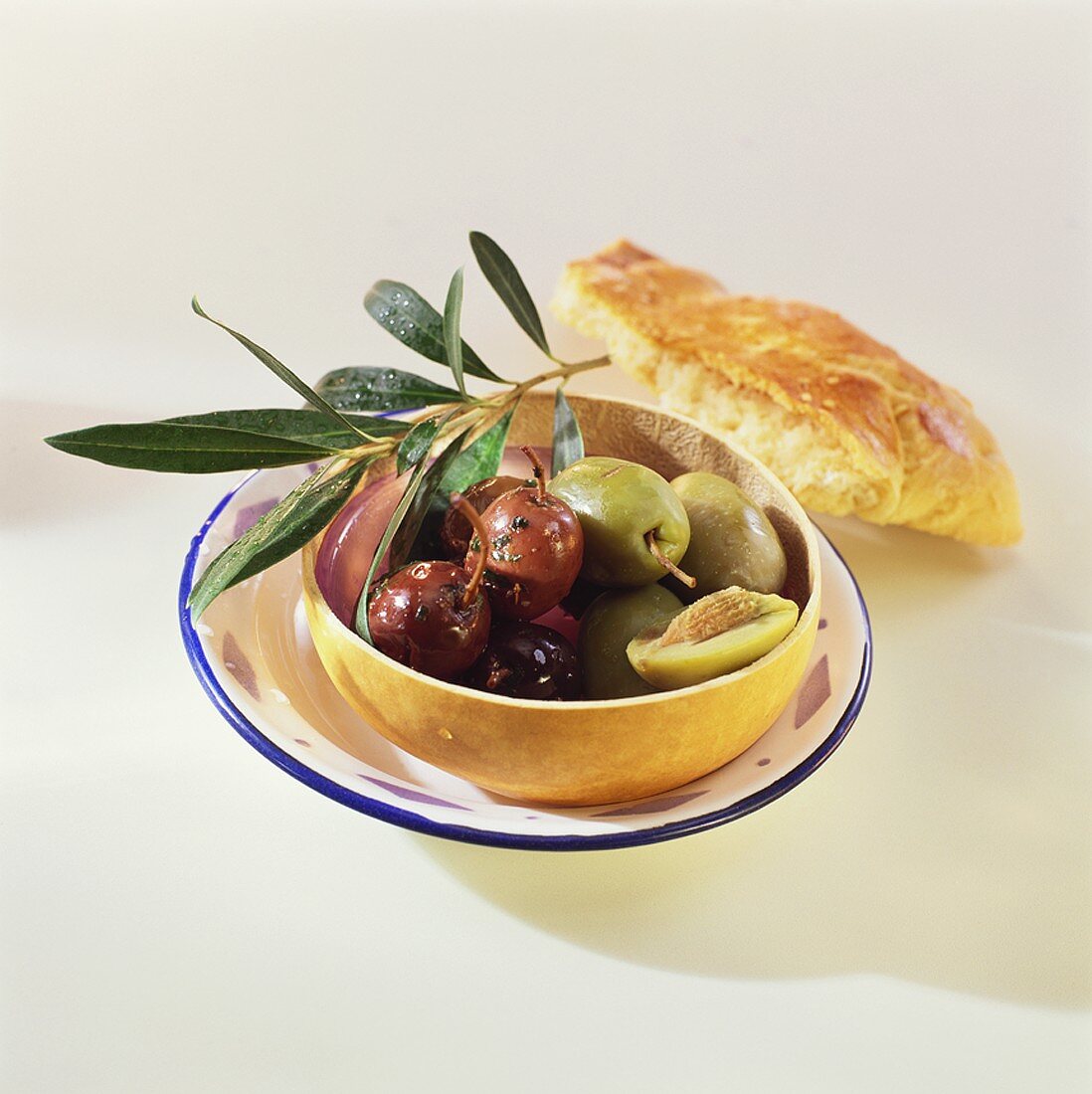 Marinated black and green olives and olive branch