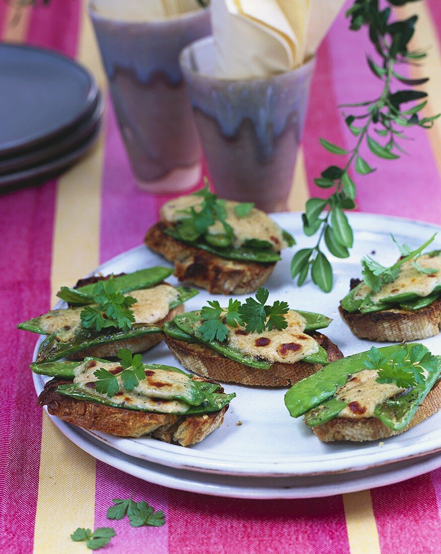 Wholemeal crostini topped with mangetout