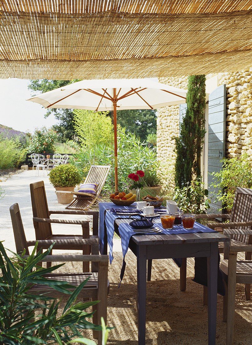 A laid breakfast table in the open air, B&B, Au Silence des Anges, in Oppède, Luberan area, Vaucluse, France