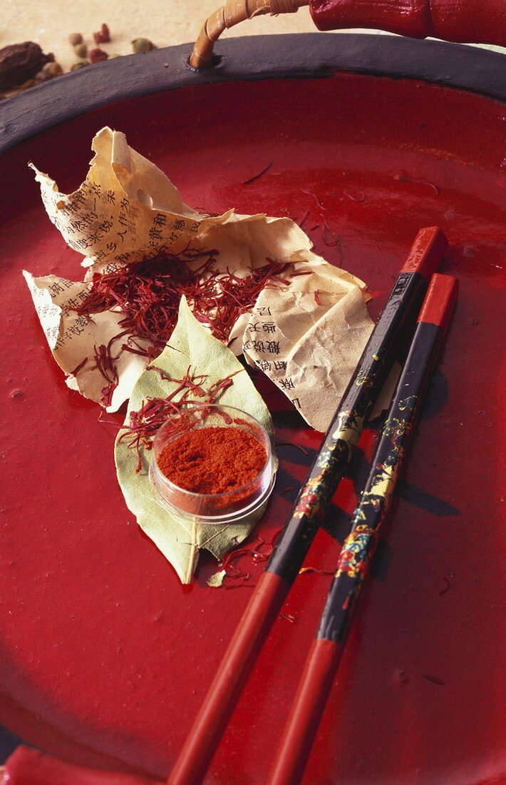 Saffron threads and saffron powder on red tray