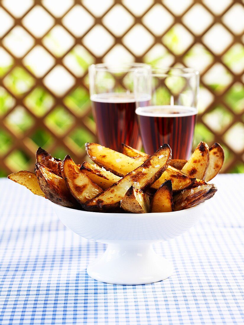 Spicy chilli potato wedges, glasses of beer