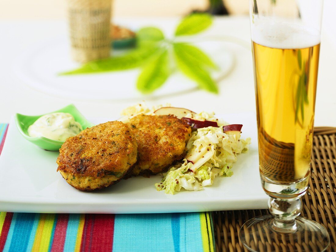 Smoked cod fish cakes with salad, glass of beer