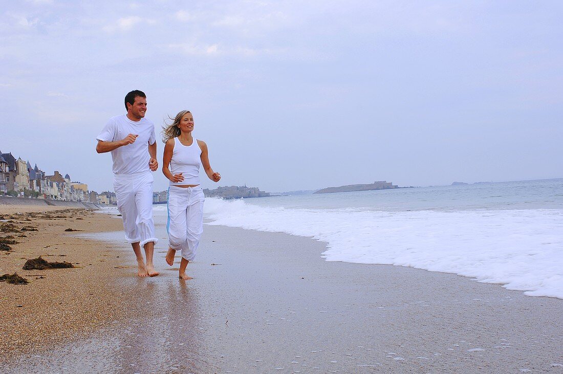 Couple running along the beach