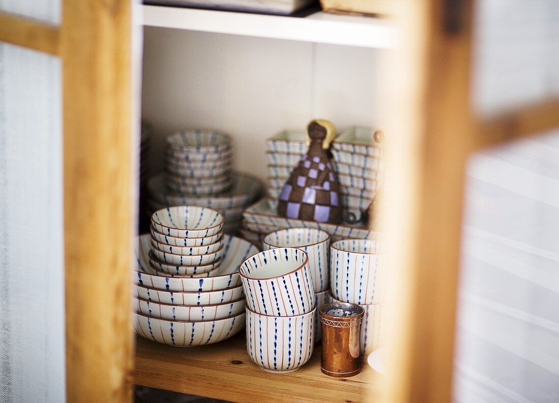 Cups and dishes in a cupboard (detail)