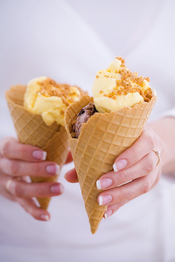 Vanilla ice cream with biscuit crumbs in ice cream cones