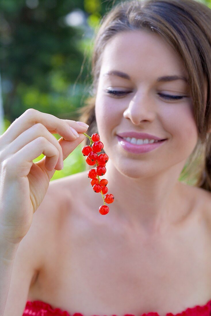 Young woman with redcurrants