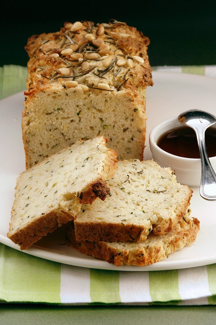 Spiced loaf with herbs and pine nuts, partly sliced