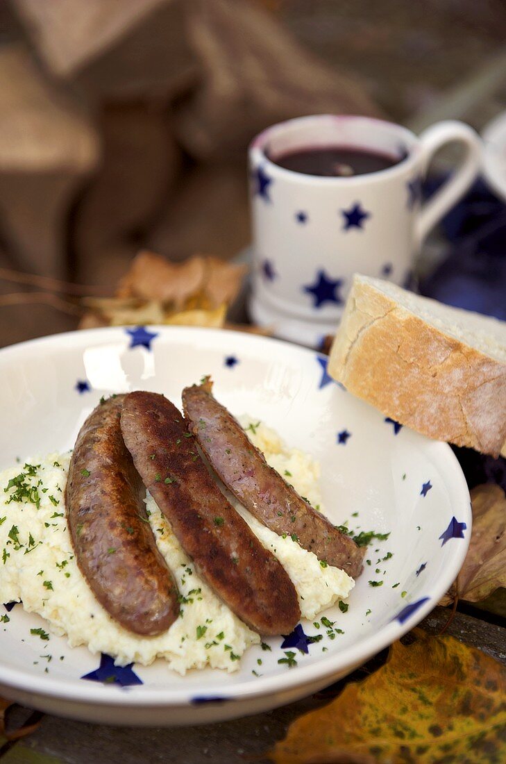 Sausages poached in beer on celeriac and apple mash