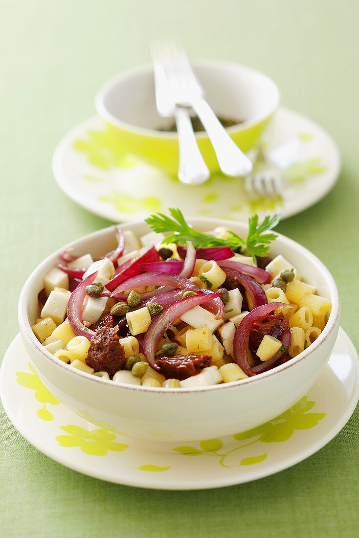 Pasta with caramelised onions, dried tomatoes, olives and feta