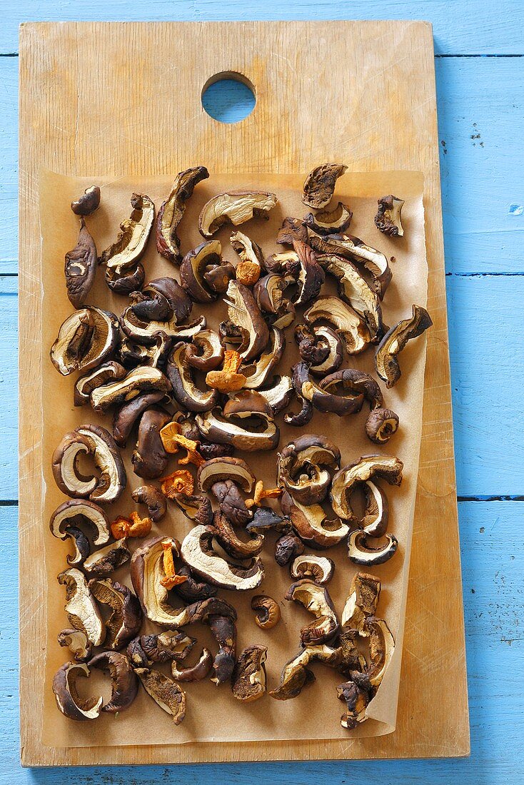 Dried mushrooms on chopping board (overhead view)