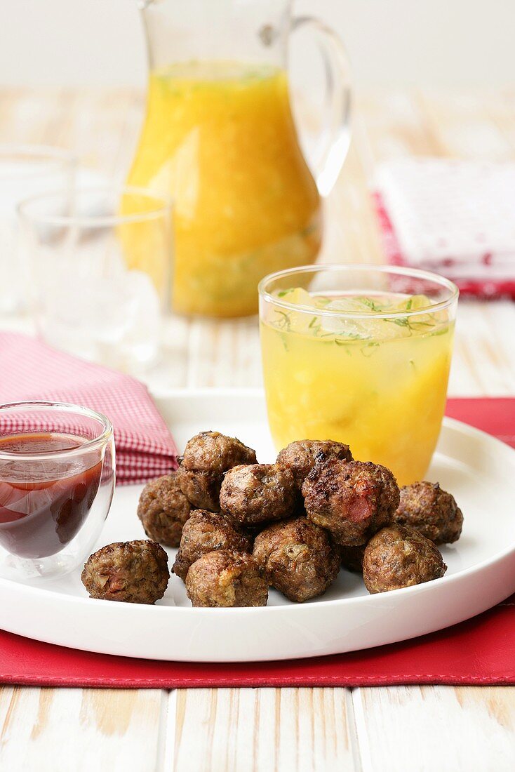 Meatballs with bacon, orange drink