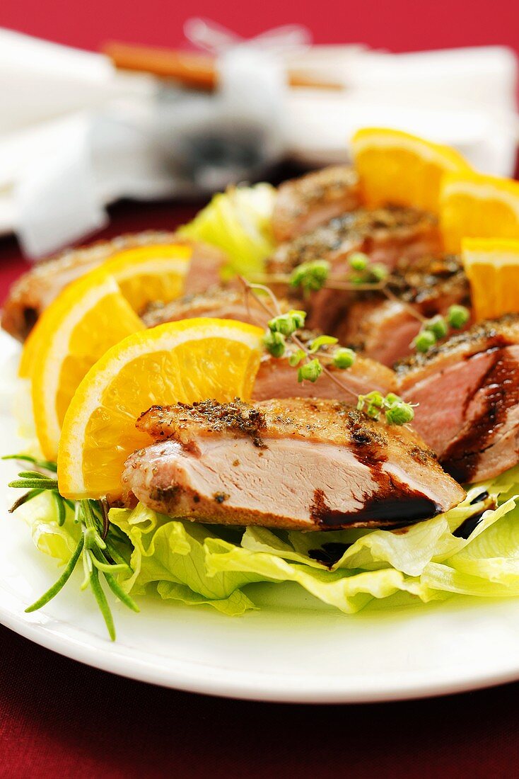 Duck breast with oranges on iceberg lettuce