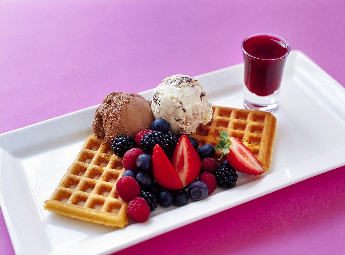 Waffles with ice cream, fresh berries and berry sauce