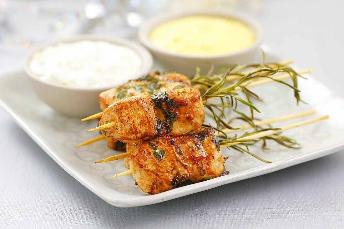 Chicken skewers with rosemary and sauces