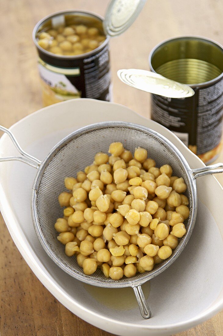Chick-peas in a sieve and in tins