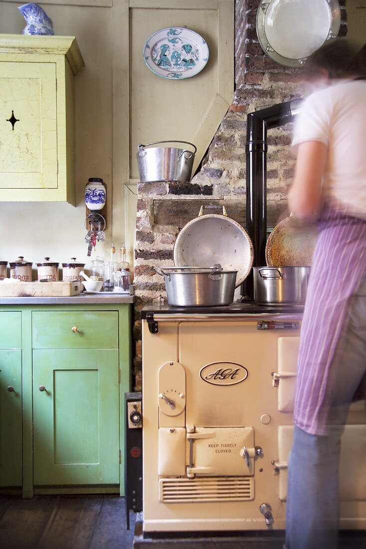 Pans on the stove in a rustic kitchen